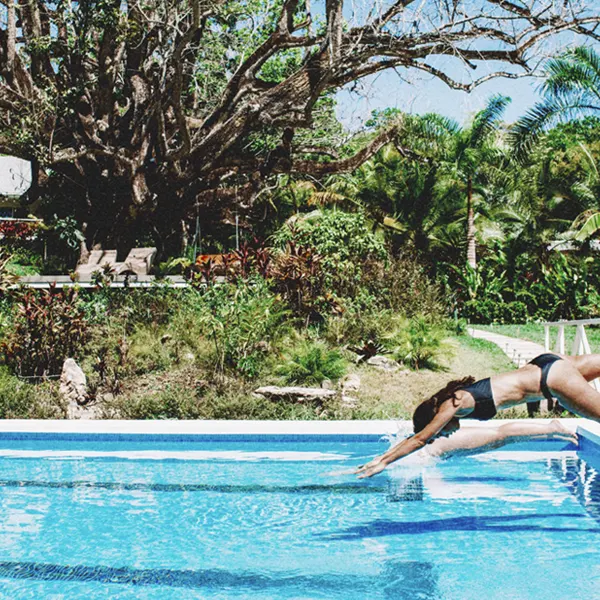 Yoga practice by the pool at Aves Retreat Center during trauma-informed yoga teacher training Costa Rica